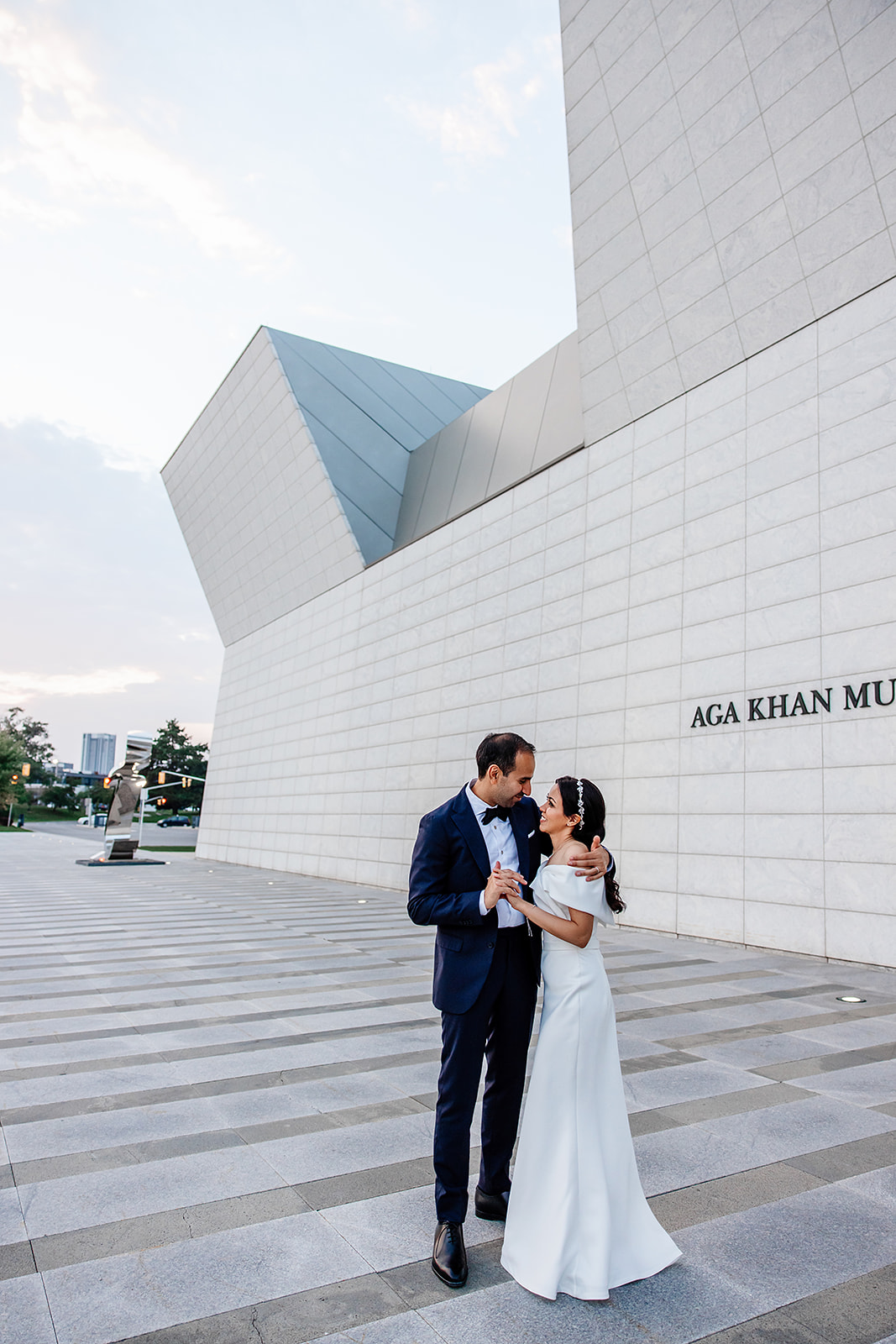 Bride and groom walking through the outdoor gardens at Aga Khan Museum during sunset wedding session
